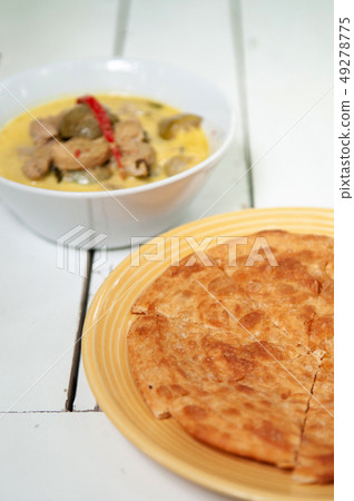 Indian roti with Thai green curry top view shot Indian roti with Thai green curry top view shot 49278775
