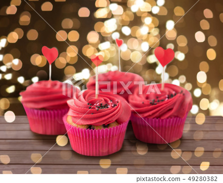 close up of cupcakes with heart cocktail sticks 49280382