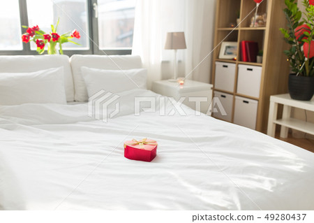 heart shaped gift box on bed at home bedroom heart shaped gift box on bed at home bedroom 49280437