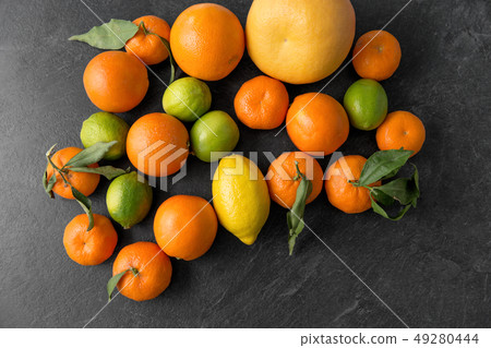 close up of citrus fruits on stone table close up of citrus fruits on stone table 49280444