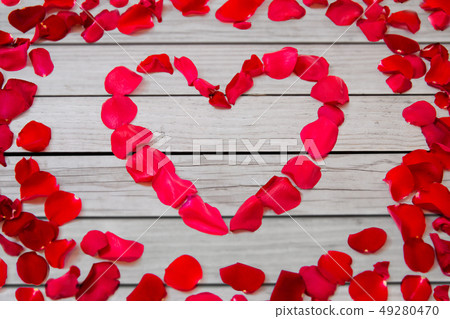 close up of red rose petals in heart shape close up of red rose petals in heart shape 49280470
