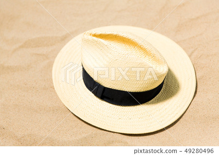 straw hat on beach sand straw hat on beach sand 49280496