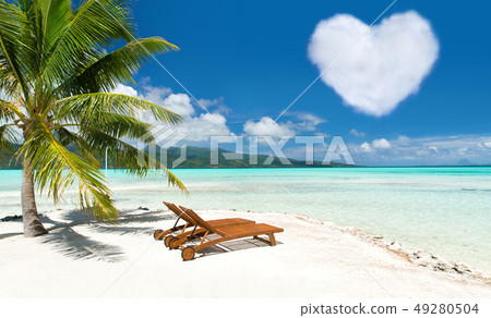beach with two sunbeds and heart shaped cloud beach with two sunbeds and heart shaped cloud 49280504