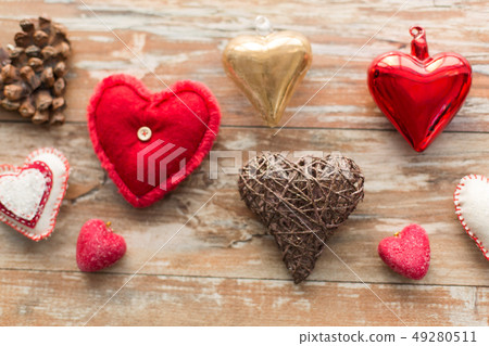 heart shaped decorations on wooden background heart shaped decorations on wooden background 49280511