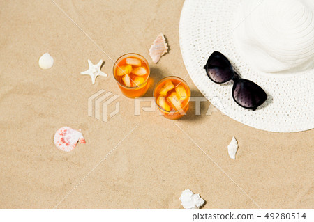 cocktails, sun hat and sunglasses on beach sand cocktails, sun hat and sunglasses on beach sand 49280514