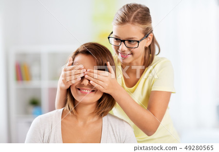 happy mother and daughter playing guess who game 49280565