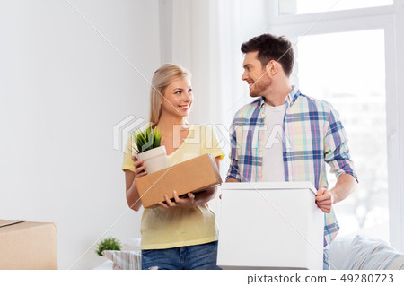 happy couple with boxes moving to new home happy couple with boxes moving to new home 49280723