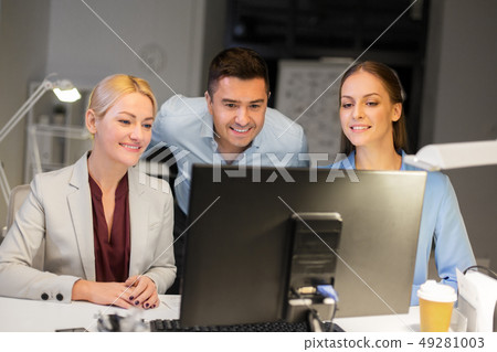 business team with computer working late at office business team with computer working late at office 49281003