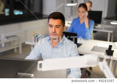 man with computer working at night office 49281087