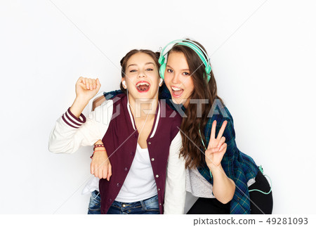 teenage girls in earphones listening to music teenage girls in earphones listening to music 49281093