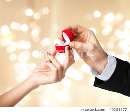 man giving diamond ring to woman on valentines day man giving diamond ring to woman on valentines day 49281277