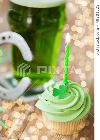 green cupcake with candle, beer and horseshoe green cupcake with candle, beer and horseshoe 49281325