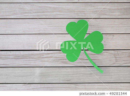 green paper shamrock on wooden background green paper shamrock on wooden background 49281344