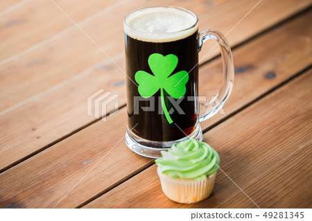 glass of beer with shamrock and green cupcake glass of beer with shamrock and green cupcake 49281345