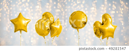 many metallic gold helium balloons on white 49281547