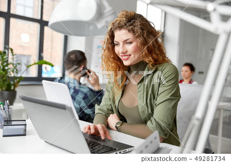 happy woman with computer working at office happy woman with computer working at office 49281734