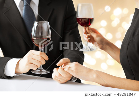 close up of engaged couple drinking red wine close up of engaged couple drinking red wine 49281847