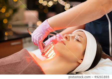 young woman having face microdermabrasion at spa 49281893
