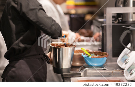 chef making chocolate at confectionery shop 49282283