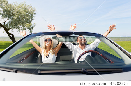 happy man and woman driving in cabriolet car 49282371