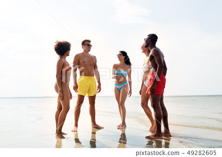 happy friends hugging on summer beach 49282605