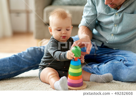 father playing with little baby daughter at home father playing with little baby daughter at home 49282608