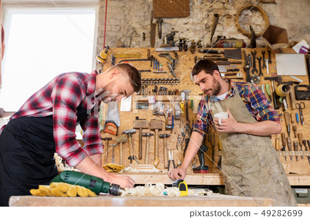 carpenters working and drinking coffee at workshop carpenters working and drinking coffee at workshop 49282699