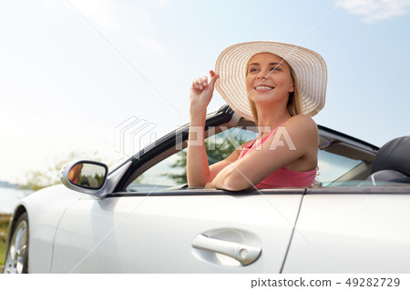happy young woman in convertible car happy young woman in convertible car 49282729