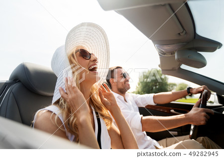 happy man and woman driving in cabriolet car 49282945
