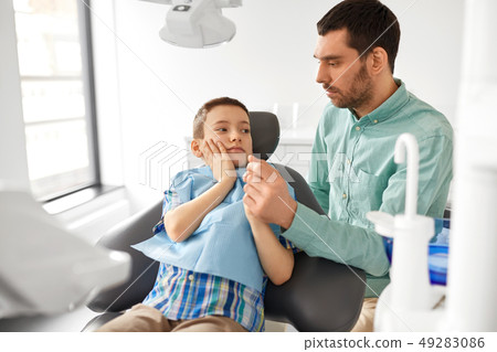 father supporting son at dental clinic father supporting son at dental clinic 49283086