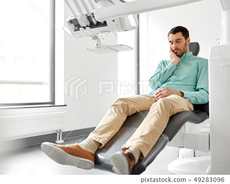 patient suffering from toothache at dental clinic 49283096