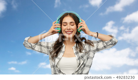 happy young woman or teenage girl with headphones 49283230