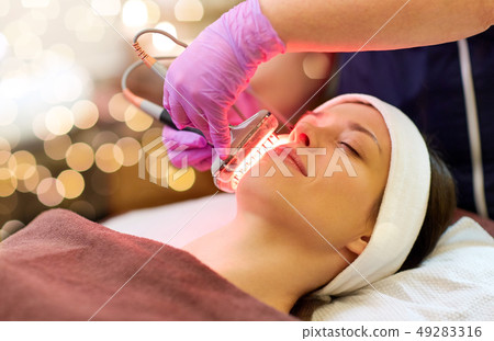 young woman having face microdermabrasion at spa young woman having face microdermabrasion at spa 49283316