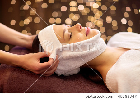 woman having face massage with towel at spa woman having face massage with towel at spa 49283347