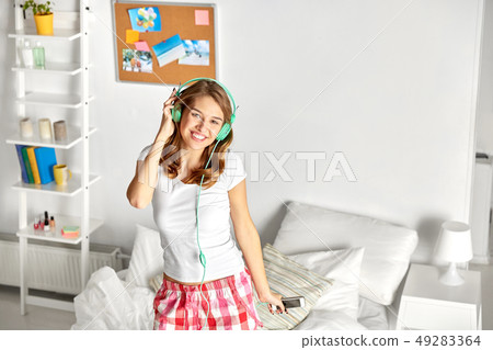 happy woman in headphones having fun at home 49283364