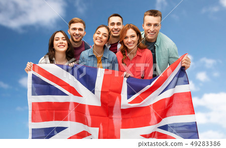 group of smiling friends with british flag