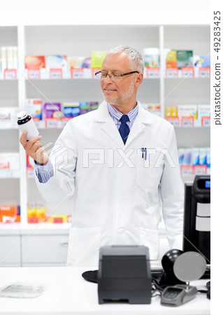 senior apothecary with drug at pharmacy senior apothecary with drug at pharmacy 49283425