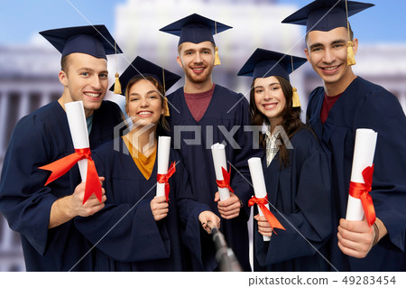 happy graduates with diplomas taking selfie 49283454