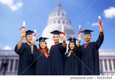 graduates in mortar boards with diplomas 49283464