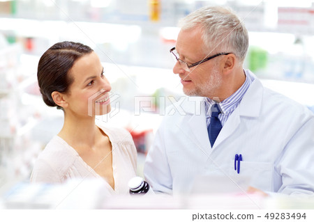 apothecary and woman with drug at pharmacy apothecary and woman with drug at pharmacy 49283494