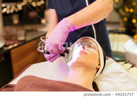 young woman having face microdermabrasion at spa 49283757