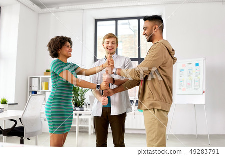 happy creative team making high five at office happy creative team making high five at office 49283791