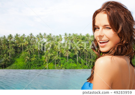 happy woman over infinity edge pool in sri lanka 49283959