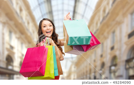 woman with shopping bags over mall background woman with shopping bags over mall background 49284090