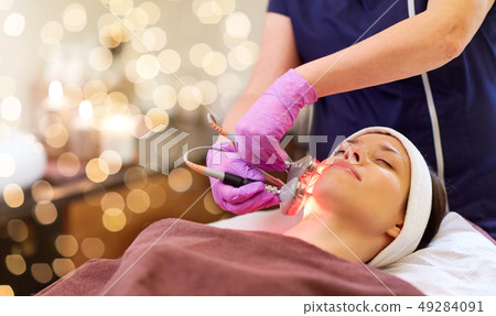 young woman having face microdermabrasion at spa young woman having face microdermabrasion at spa 49284091