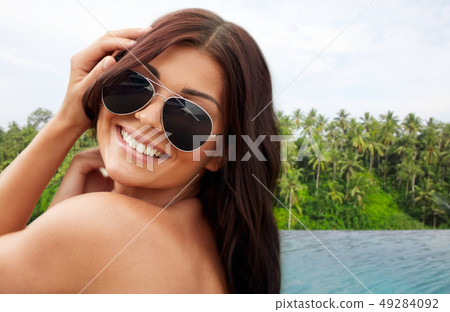 happy woman over infinity edge pool in sri lanka happy woman over infinity edge pool in sri lanka 49284092