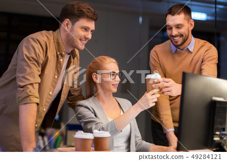 business team with coffee working at night office 49284121