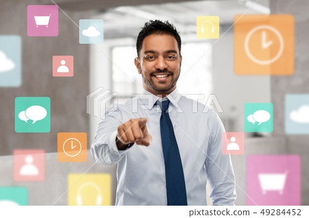 businessman pointing to you or app icons at office businessman pointing to you or app icons at office 49284452