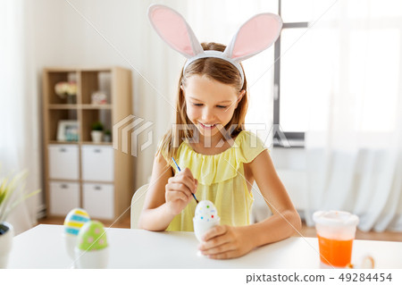 happy girl coloring easter eggs at home happy girl coloring easter eggs at home 49284454