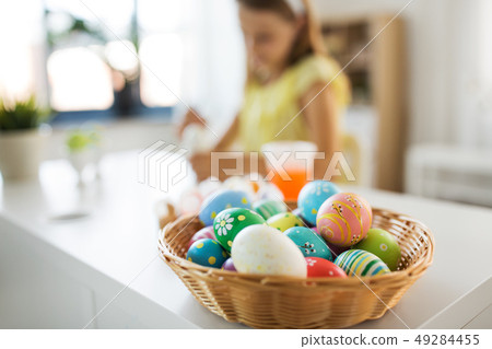 colored easter eggs and girl on background at home colored easter eggs and girl on background at home 49284455